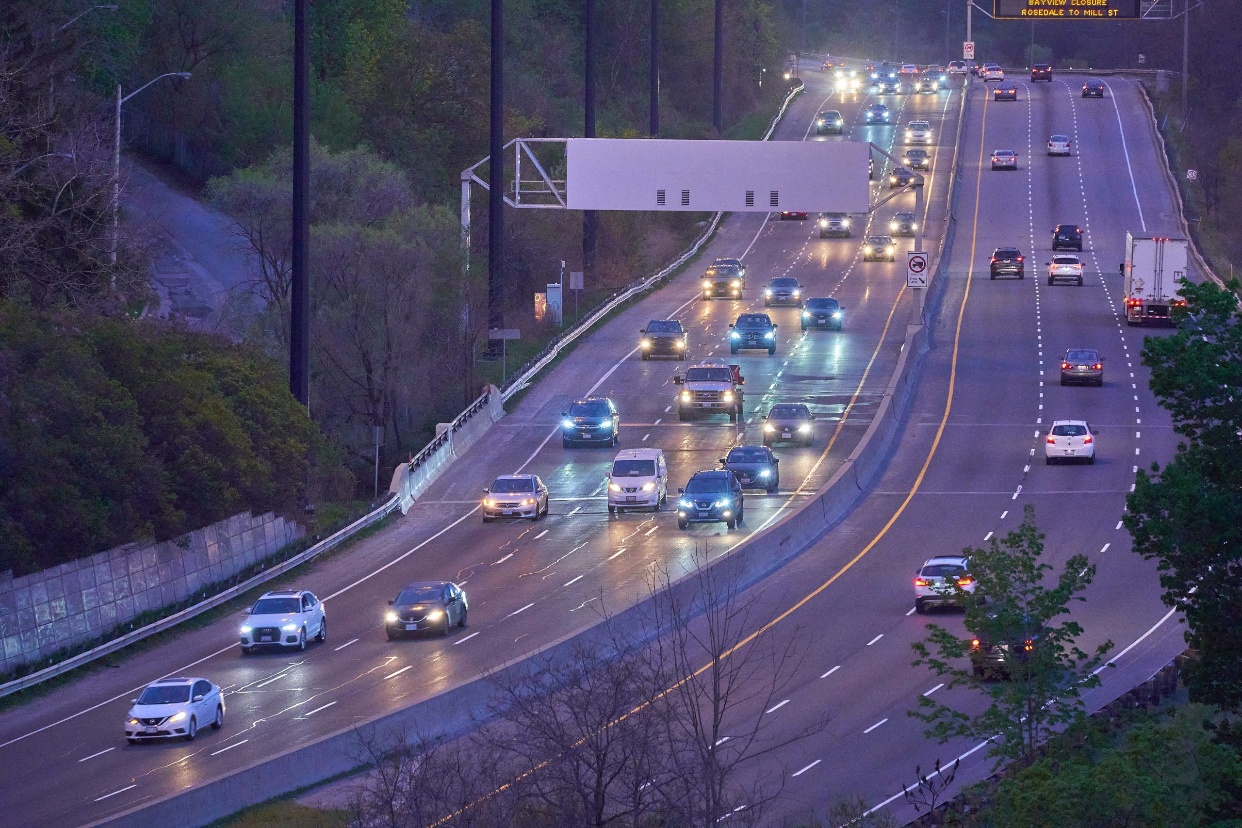 Cars move through a busy highway tunnel, with one side congested and the other relatively empty, illustrating uneven AI adoption.