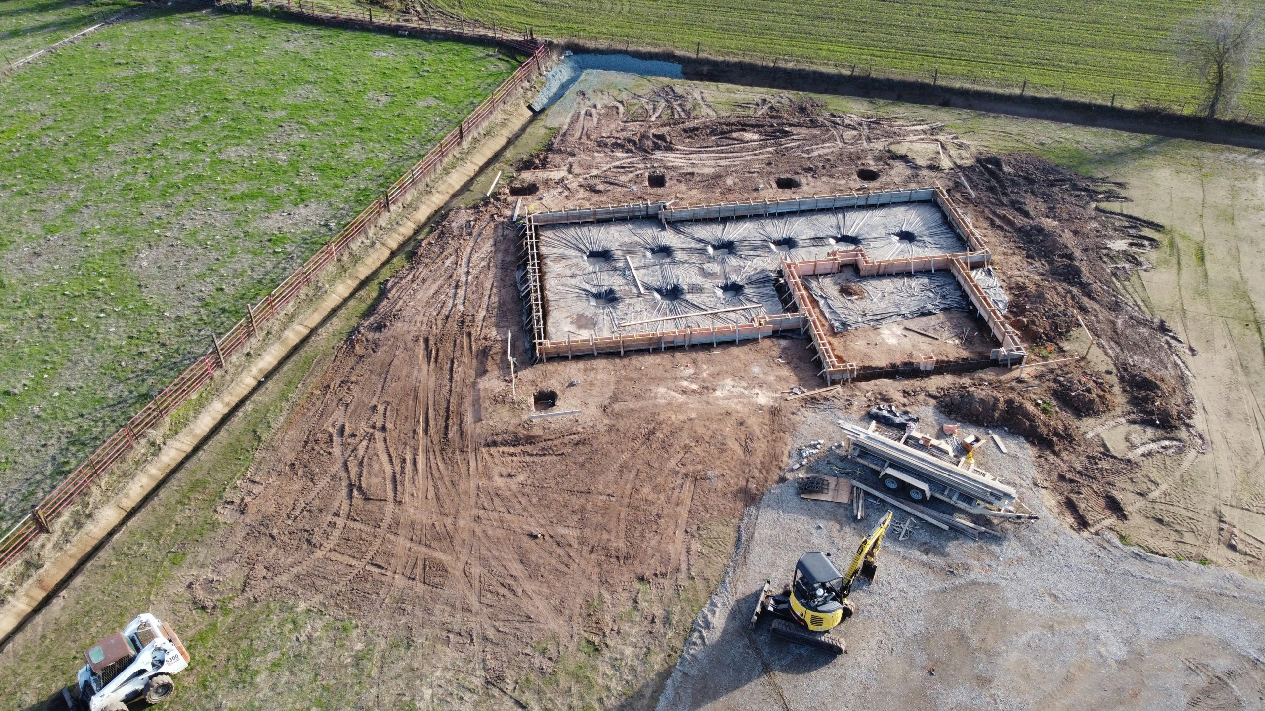 Early stage building construction showing the concrete foundation before the rest of the structure is built, reinforcing the idea that the leadership pipeline is the foundation of all businesses.